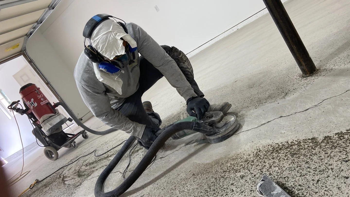 The New Life Garages trained install crew applying a polyurea floor coating