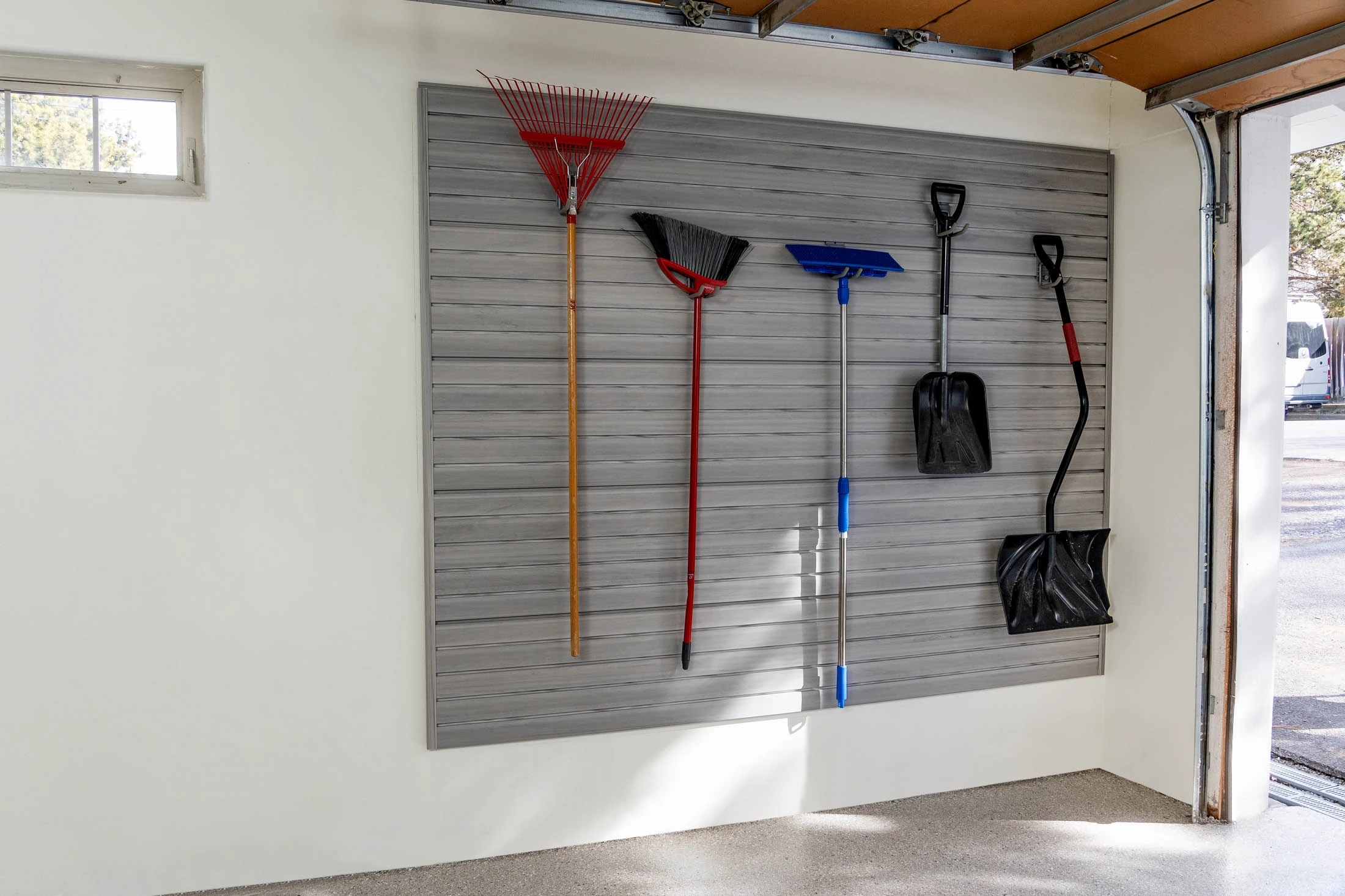 Finished garage with slatwall wall storage keeping tools and gear organized off the floor