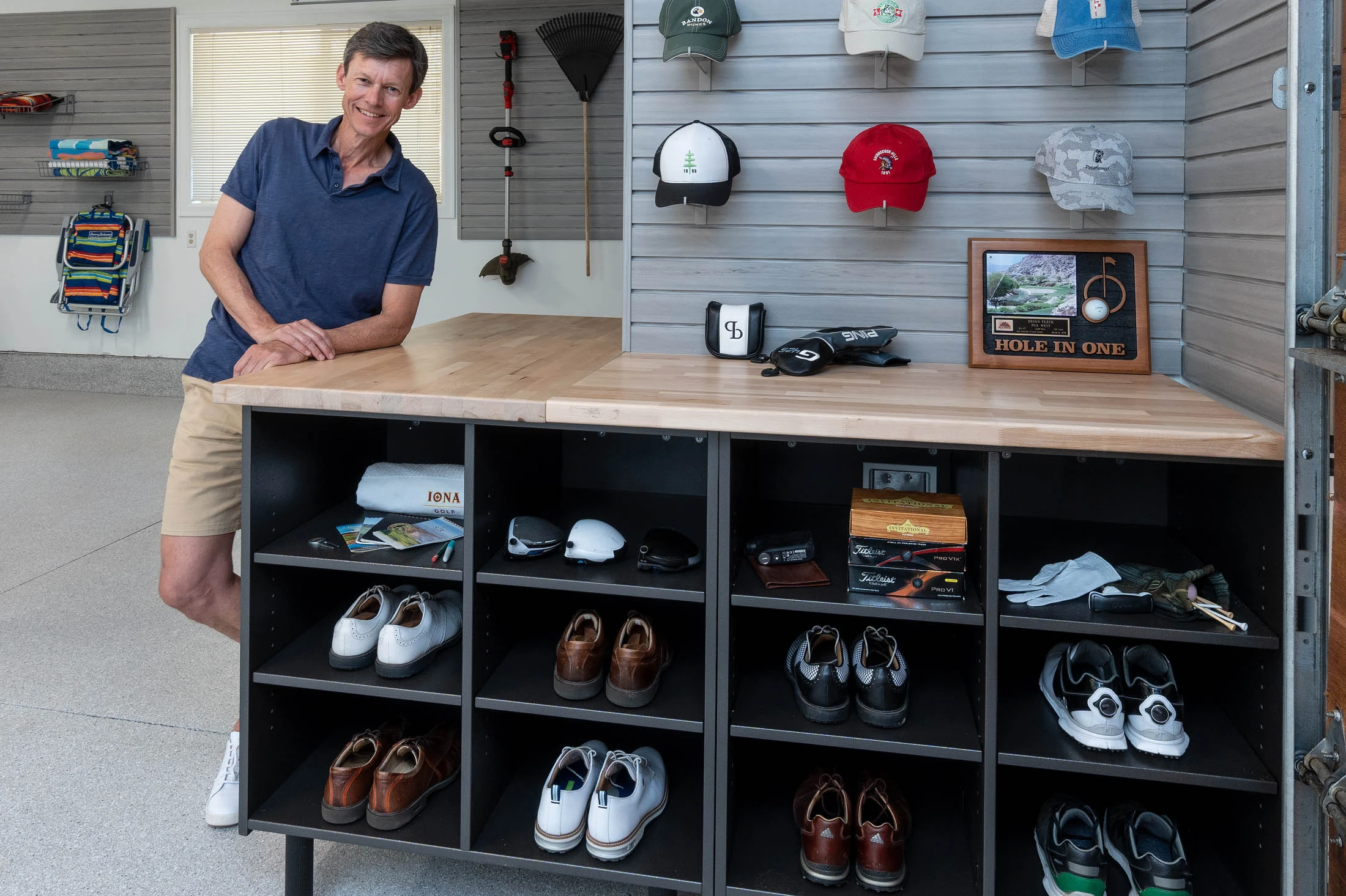 Customer leaning against a slatwall golf cubby and gear storage system