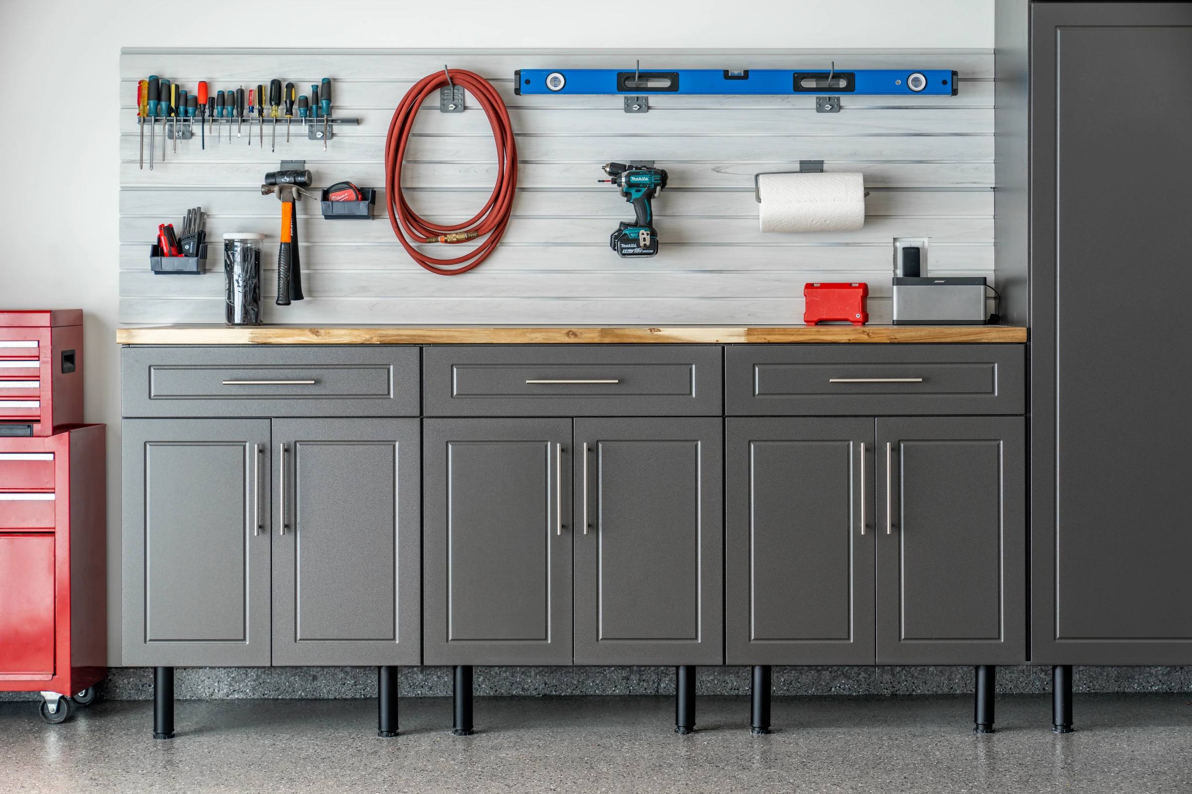 Close-up of a powder-coated garage workbench built into a cabinet run